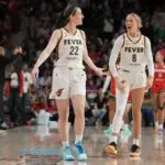 Caitlin Clark #22 of the Indiana Fever celebrates with Sophie Cunningham #8 after scoring the game-winning three pointer during the second half against the Washington Mystics.