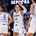 Veronica Burton #22 of the Golden State Valkyries celebrates a 83-75 win over the Toronto Tempo with teammates Kaitlyn Chen #2 and Janelle Salaun #13 after a WNBA game at Coca-Cola Coliseum