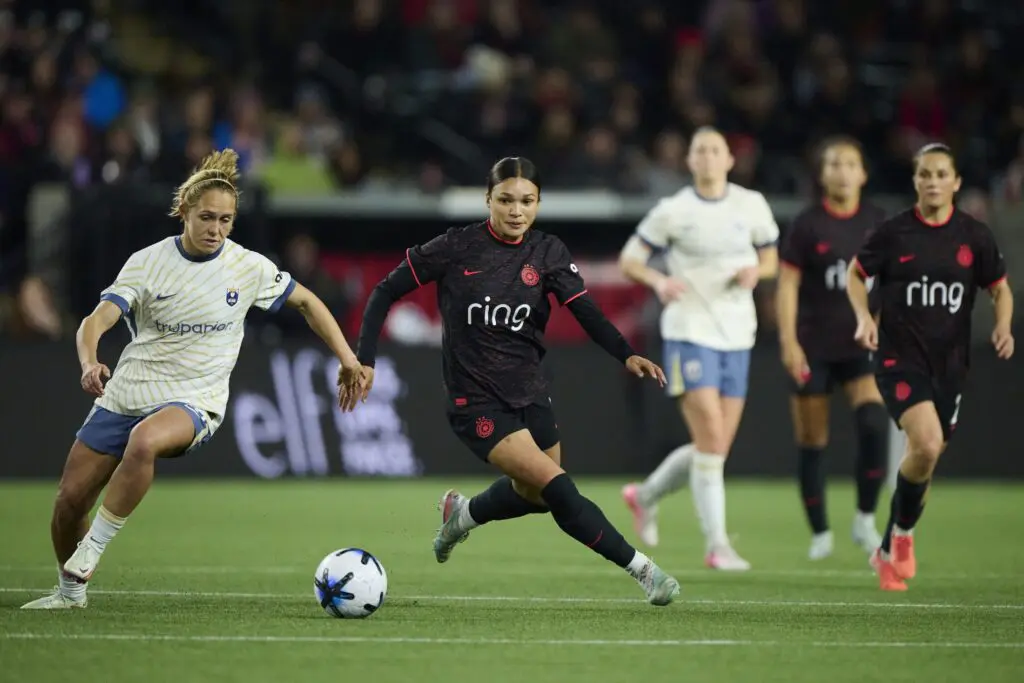 Portland Thorns FC forward Sophia Wilson (9) chases down a lose ball during the second half against Seattle Reign FC forward Brittany Ratcliffe (13) at Providence Park.