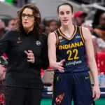 Indiana Fever head coach Stephanie White talks with Indiana Fever guard Caitlin Clark (22).