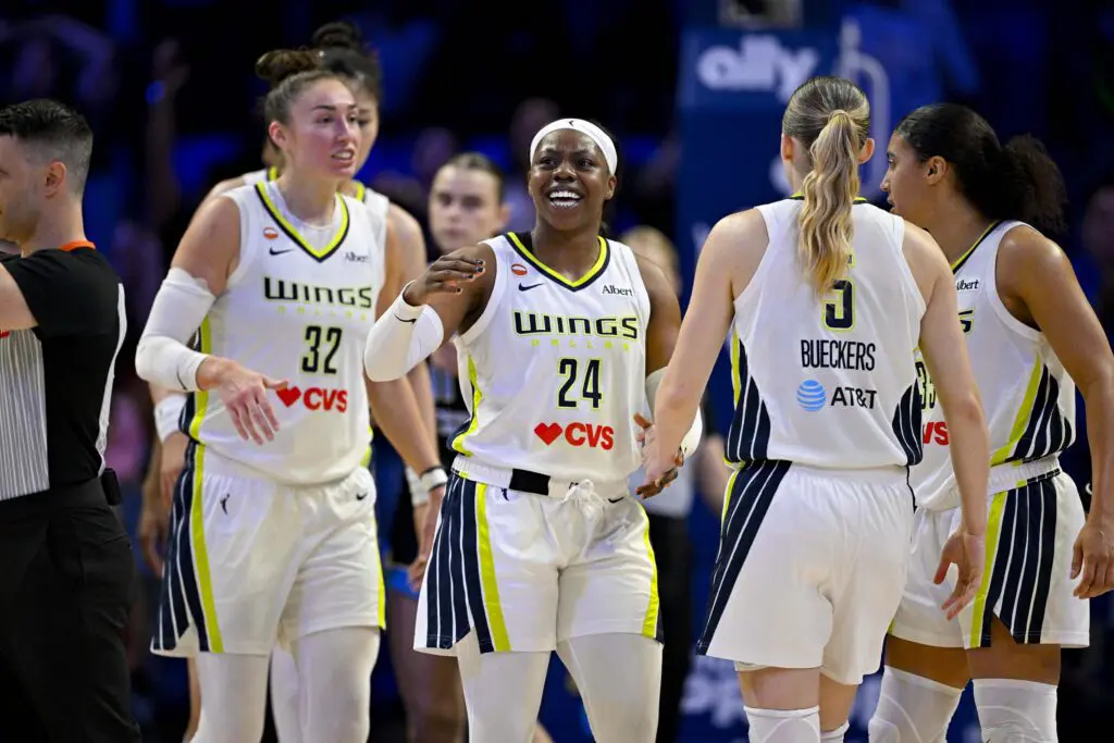 Dallas Wings guard Paige Bueckers (5) and forward Jessica Shepard (32) and guard Arike Ogunbowale (24) celebrates after Bueckers is fouled on a basket during the fourth quarter against the Chicago Sky.