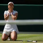 Alexandra Eala of the Philippines celebrates winning her match against Iga Swiatek of Poland on day six at All England Lawn Tennis and Croquet Club