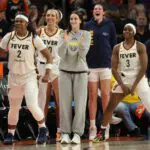 Indiana Fever guard Caitlin Clark (center) celebrates with forward Myisha Hines-Allen (2) and guard Raven Johnson (3) against the Phoenix Mercury at Mortgage Matchup Center.