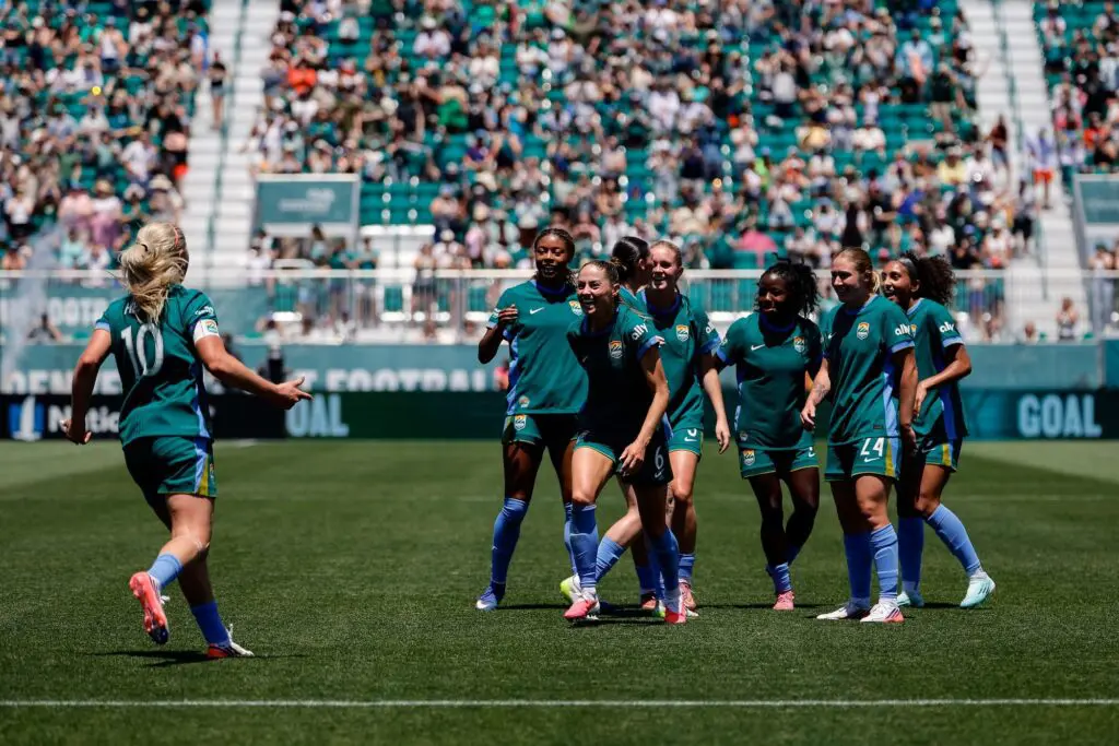 Denver Summit FC defender Janine Sonis (6) celebrates with midfielder Lindsey Heaps (10) and teammates after her goal in the first half against the Portland Thorns FC at Centennial Stadium.