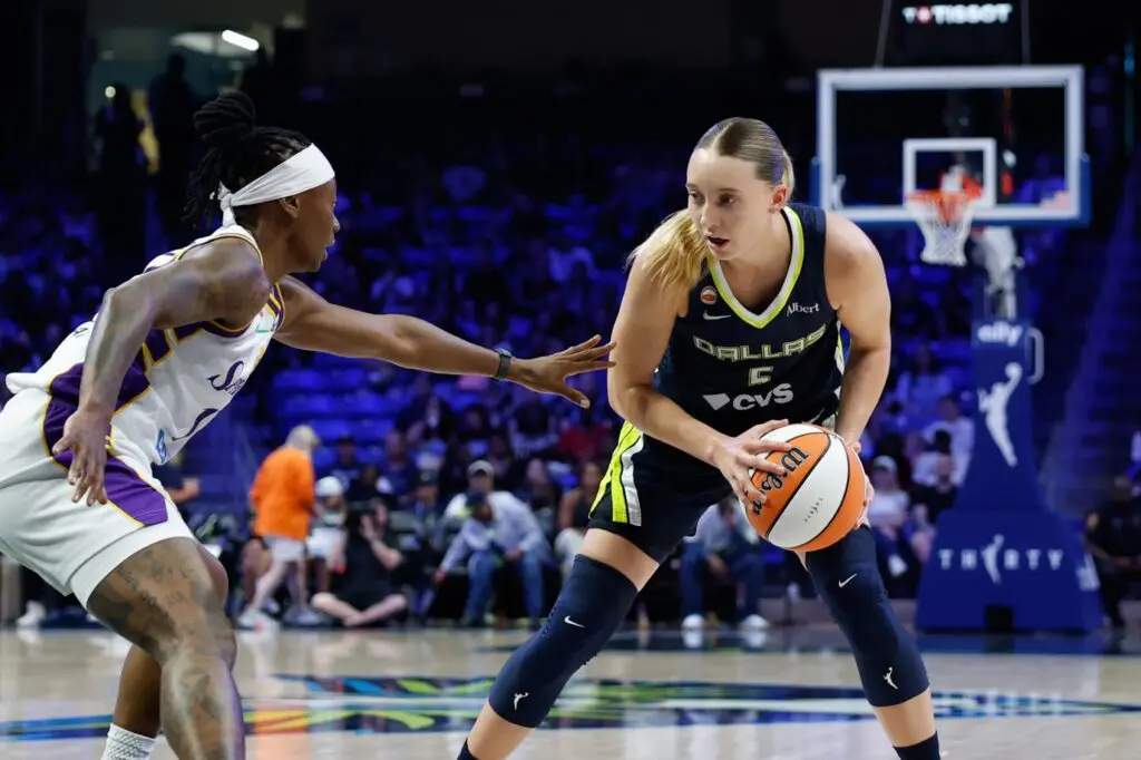 Dallas Wings guard Paige Bueckers (5) controls the ball as Los Angeles Sparks guard Erica Wheeler (17) defends during the first half at College Park Center.