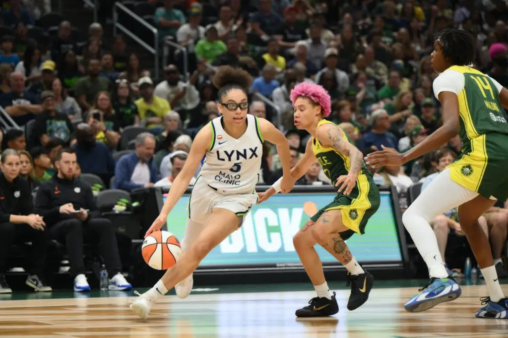Minnesota Lynx guard Olivia Miles (5) dribbles the ball while guarded by Seattle Storm guard Natisha Hiedeman (2) during the first half at Climate Pledge Arena.
