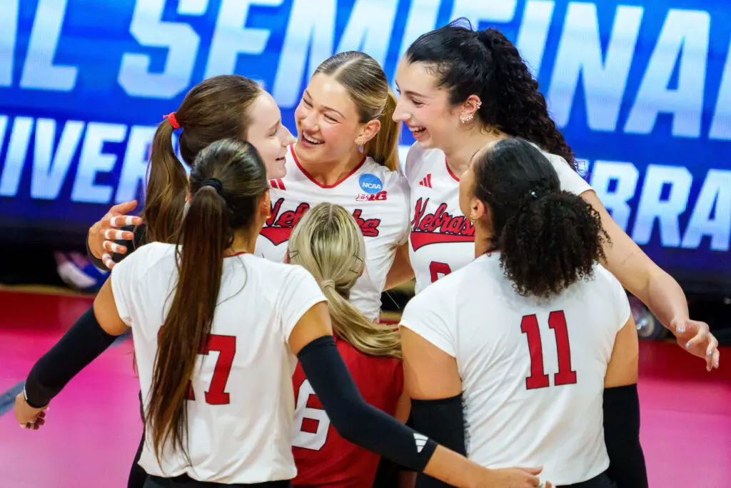 Nebraska Cornhuskers middle blocker Andi Jackson (15) and opposite hitter Virginia Adriano (9) smile after a point against the Kansas Jayhawks during the second set at Bob Devaney Sports Center.