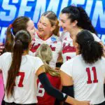 Nebraska Cornhuskers middle blocker Andi Jackson (15) and opposite hitter Virginia Adriano (9) smile after a point against the Kansas Jayhawks during the second set at Bob Devaney Sports Center.