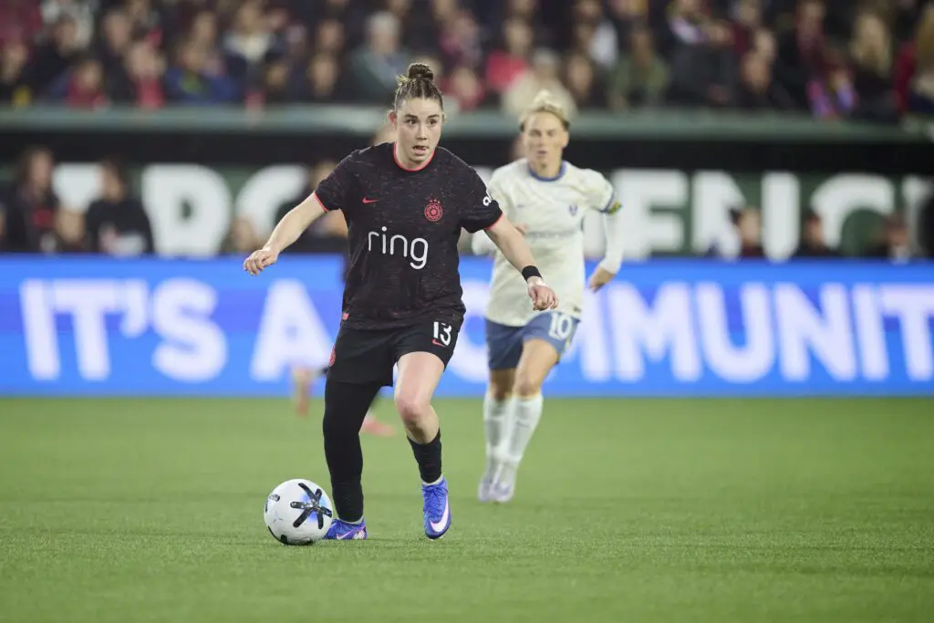Portland Thorns FC midfielder Olivia Moultrie (13) controls the ball during the first half against Seattle Reign FC midfielder Jess Fishlock (10) at Providence Park.