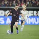 Portland Thorns FC midfielder Olivia Moultrie (13) controls the ball during the first half against Seattle Reign FC midfielder Jess Fishlock (10) at Providence Park.