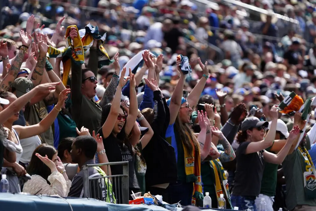 Denver Summit FC fans cheer during the match against the Washington Spirit at Empower Field at Mile High.