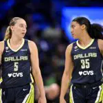 Dallas Wings guard Paige Bueckers (5) and guard Azzi Fudd (35) walk back on to the court during the first half against the Seattle Storm.