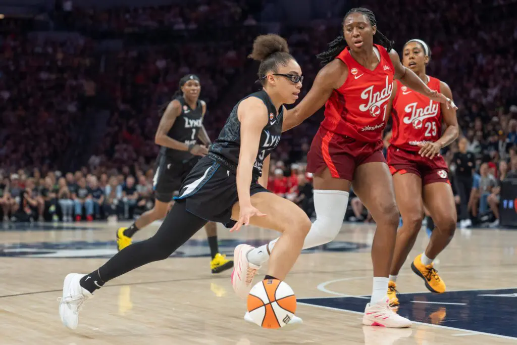 Minnesota Lynx guard Olivia Miles (5) drives to the basket as Indiana Fever center-forward Aliyah Boston (7) defends in the first quarter at Target Center.
