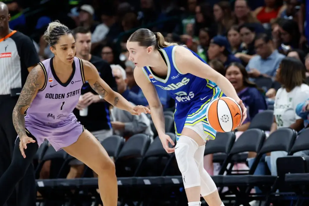 Dallas Wings guard Paige Bueckers (5) controls the ball as Golden State Valkyries forward Gabby Williams (1) defends during the second half at American Airlines Center.
