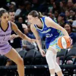 Dallas Wings guard Paige Bueckers (5) controls the ball as Golden State Valkyries forward Gabby Williams (1) defends during the second half at American Airlines Center.