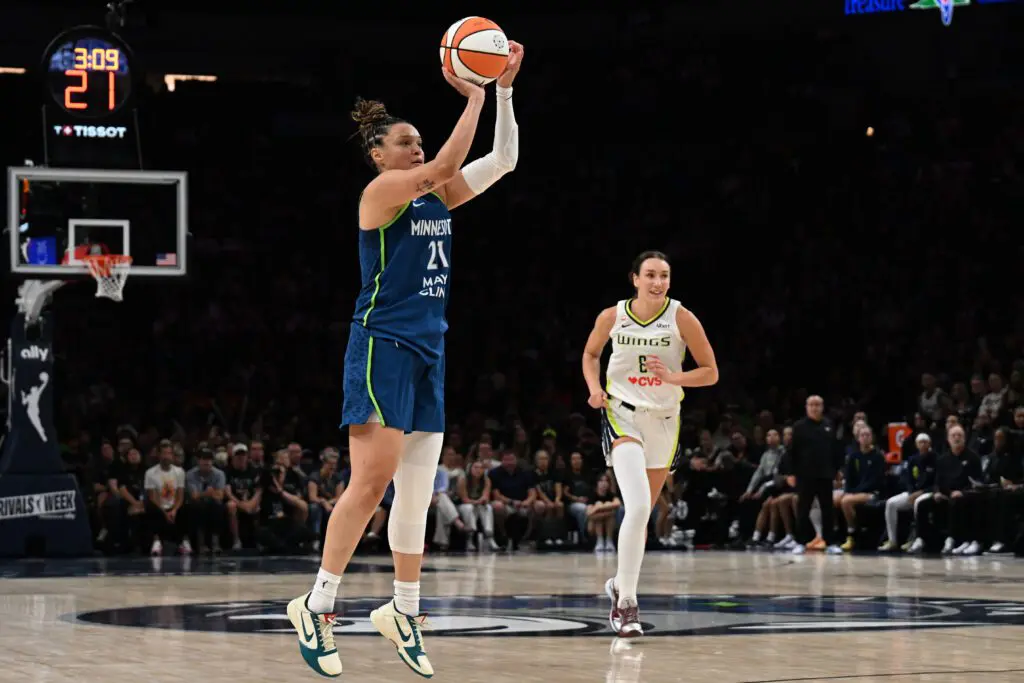Minnesota Lynx guard Kayla McBride (21) shoots a three point basket as Dallas Wings forward Alanna Smith (8) looks on during the third quarter at Target Center.