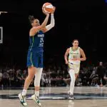 Minnesota Lynx guard Kayla McBride (21) shoots a three point basket as Dallas Wings forward Alanna Smith (8) looks on during the third quarter at Target Center.