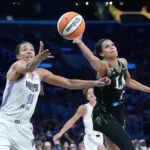 LA Sparks guard Rae Burrell (12) and Golden State Valkyries center Kiah Stokes (41) reach for the ball in the second half at Crypto.com Arena.