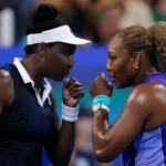 Serena Williams and Venus Williams of the United States talk after a point against Marta Kostyuk of Ukraine and Peyton Stearns of the United States in their doubles match during the Cincinnati Open at Lindner Family Tennis Center.