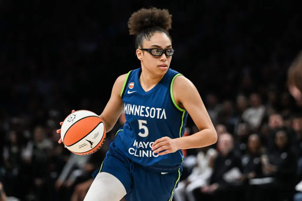 Minnesota Lynx guard Olivia Miles (5) brings the ball up court against the Dallas Wings at Target Center.