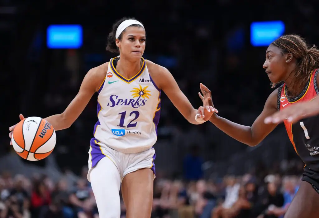 Los Angeles Sparks guard Rae Burrell (12) returns the ball against Connecticut Sun forward Diamond Miller (1) in the second half at TD Garden.
