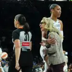 Las Vegas Aces center A'ja Wilson (22) holds back head coach Becky Hammon in the second quarter of the game against the Atlanta Dream at Michelob Ultra Arena.