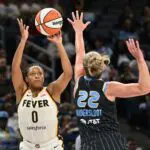 Indiana Fever guard Kelsey Mitchell (0) goes up for a shot against Chicago Sky guard Courtney Vandersloot (22) during the first half at Wintrust Arena.