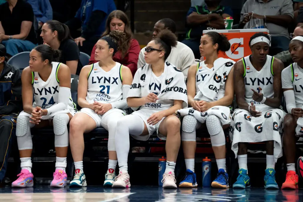Minnesota Lynx forward Napheesa Collier (24) guard Kayla McBride (21), guard Olivia Miles (5), forward Nia Coffey (12), and forward Natasha Howard (1) sit on the bench against the Golden State Valkyries in the second half at Target Center.