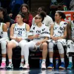 Minnesota Lynx forward Napheesa Collier (24) guard Kayla McBride (21), guard Olivia Miles (5), forward Nia Coffey (12), and forward Natasha Howard (1) sit on the bench against the Golden State Valkyries in the second half at Target Center.