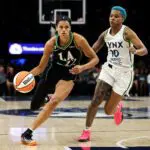 Rae Burrell #12 of the Los Angeles Sparks works around Courtney Williams #10 of the Minnesota Lynx during the first half at Target Center on August 6, 2026 in Minneapolis, Minnesota.