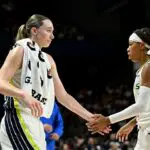 Paige Bueckers #5 of the Dallas Wings celebrates with Sug Sutton #0 during the game against the Washington Mystics.