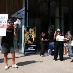 Demonstrators protest prior to the start of a WNBA game between the Indiana Fever and Minnesota Lynx at Target Center on August 02, 2026 in Minneapolis, Minnesota. Sophie Cunningham of the Indiana Fever has recently said she opposed transgender athletes participating in women’s sports.The Lynx defeated the Fever 108-100.