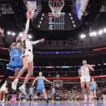 Sophie Cunningham #8 of the Indiana Fever is fouled by DiJonai Carrington #7 of the Chicago Sky during the first half at United Center on August 08, 2026.