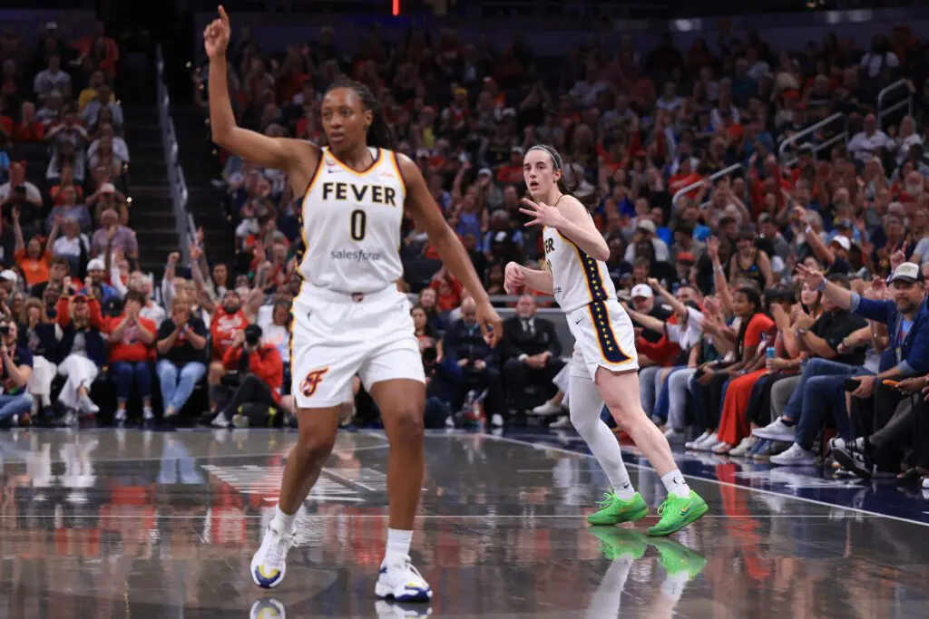 Kelsey Mitchell #0 and Caitlin Clark #22 of the Indiana Fever react after a three point shot.