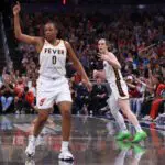 Kelsey Mitchell #0 and Caitlin Clark #22 of the Indiana Fever react after a three point shot.