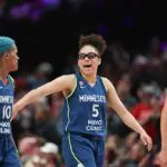 Olivia Miles #5 of the Minnesota Lynx reacts alongside Courtney Williams #10 during the fourth quarter against the Portland Fire at Moda Center on August 12, 2026 in Portland, Oregon.
