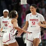 Lauren Betts #51 of the Washington Mystics reacts after a timeout is called during the first half of the game against the Portland Fire at Moda Center on August 23, 2026.