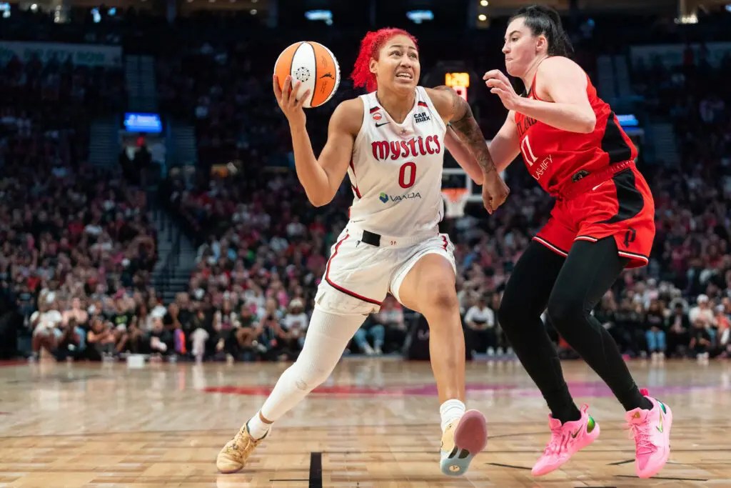 Shakira Austin #0 of the Washington Mystics drives to the basket against Megan DiLeo #17 of the Portland Fire during the second half of the game at Moda Center.