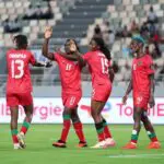 Malawi women’s national football team celebrates on the pitch after beating Algeria to make the 2026 WAFCON final.