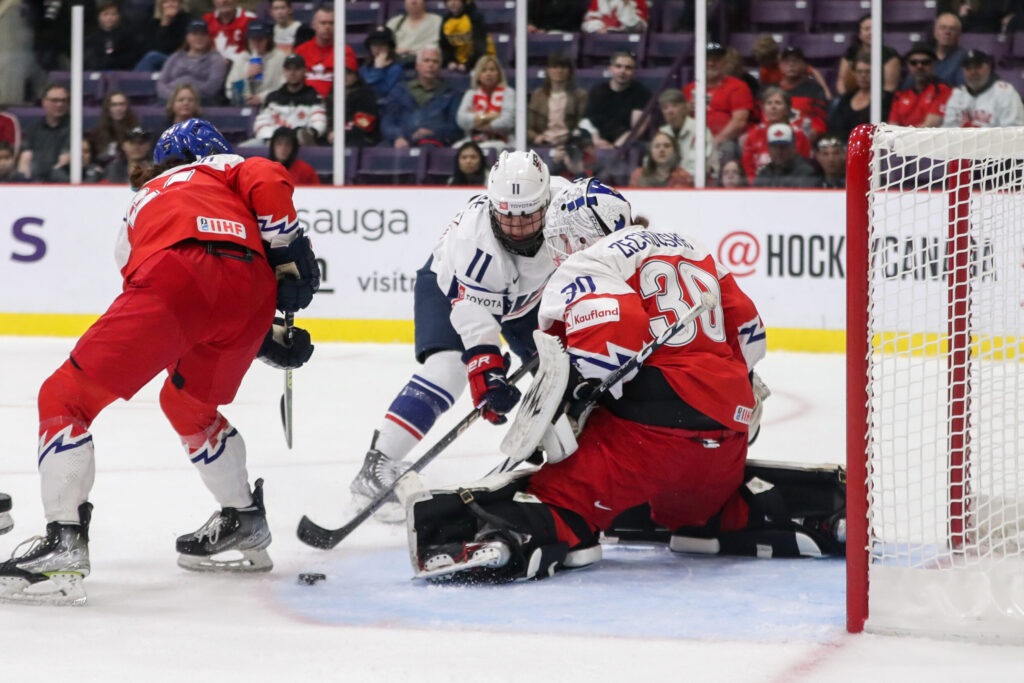 U.S. women's hockey player Abby Roque #11 looks to shoot on Czechia goaltender Katerina Zechovska