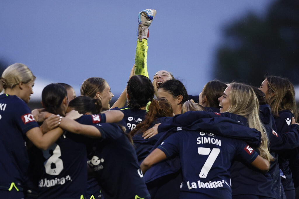 Melbourne Victory goalkeeper Casey Dumont celebrates with her team after winning the A-League semifinal over Melbourne City.