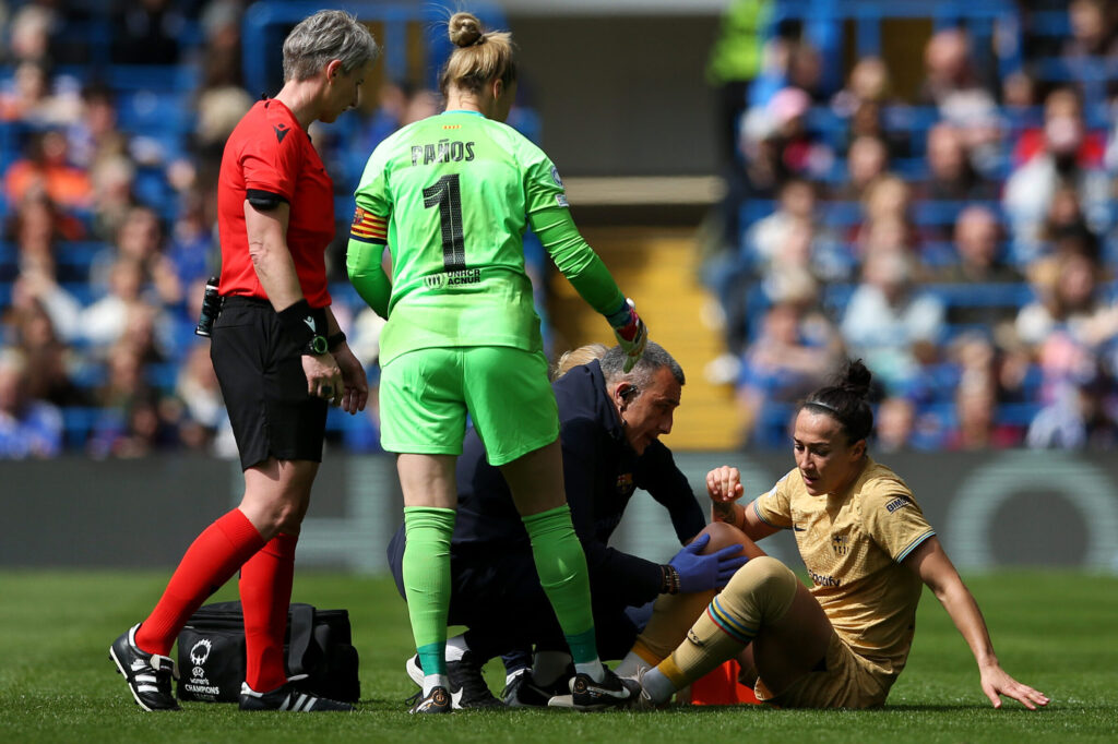 Lucy Bronze is tended to after going down with a knee injury