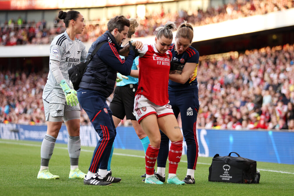 arsenal's laura wienroither being helped off the field after tearing her acl