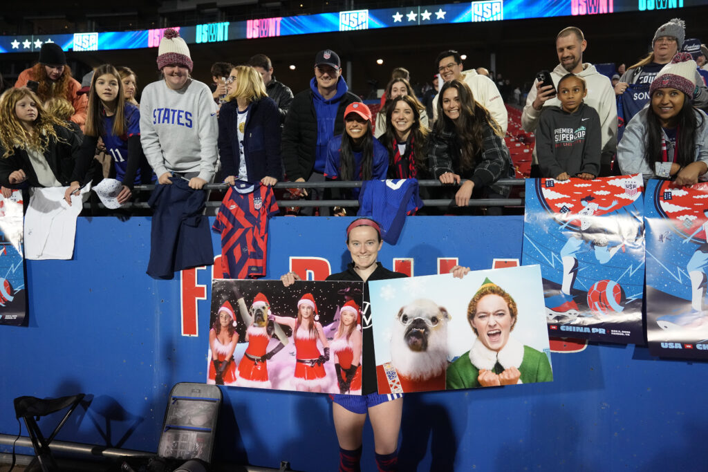 Rose Lavelle poses for a photo with some artwork after playing China PR at Toyota Stadium on December 05, 2023. (Brad Smith/ISI Photos/USSF/Getty Images for USSF)