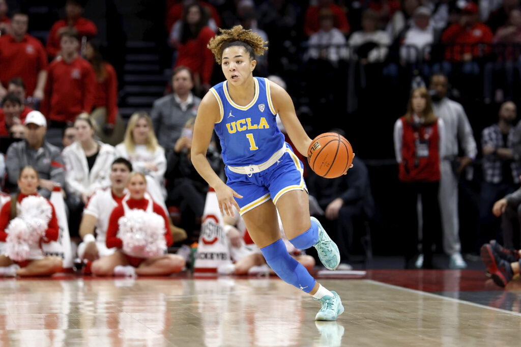 Kiki Rice of UCLA dribbles the ball during an NCAA women's college basketball game.