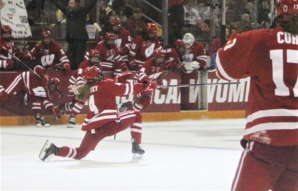 Wisconsin hockey player Caroline Harvey celebrates after scoring the overtime winner to send the Badgers to the 2023 NCAA women's hockey championship game.