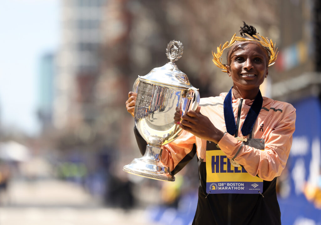Hellen Obiri, winner of the women's division of the Boston Marathon, poses with the Boston Marathon trophy