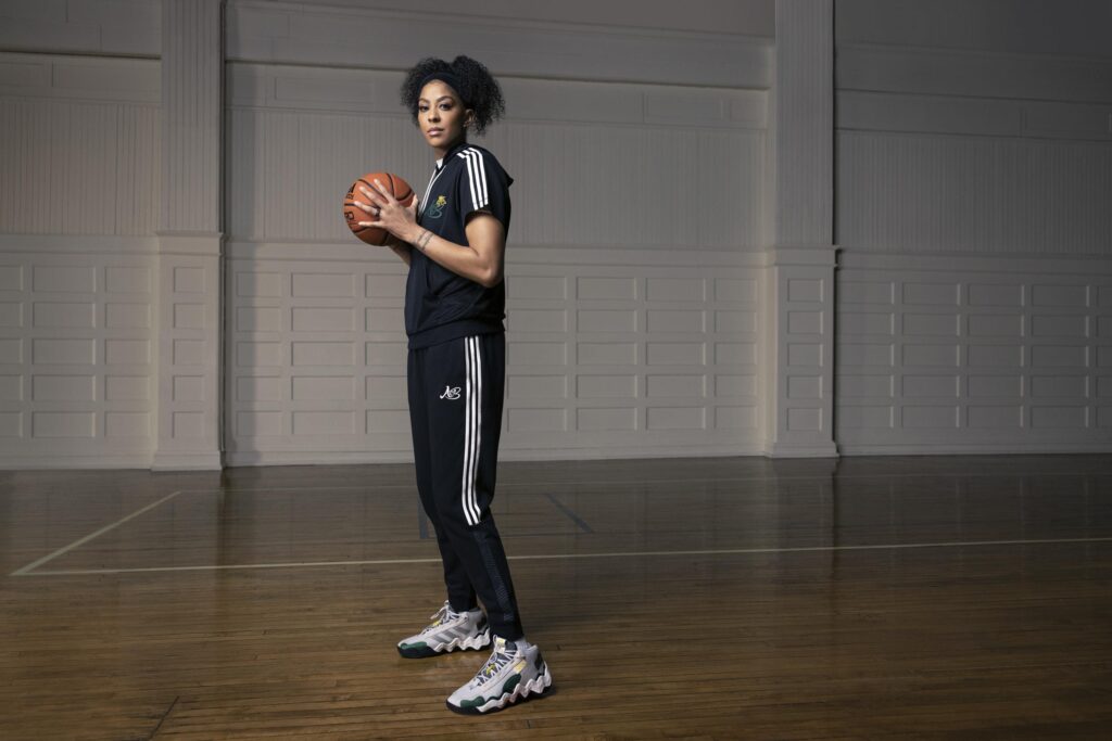 candace parker posing with basketball in adidas track suit