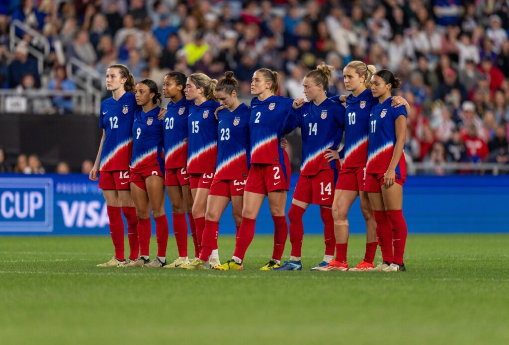 The USWNT stands on the field during penalty kicks