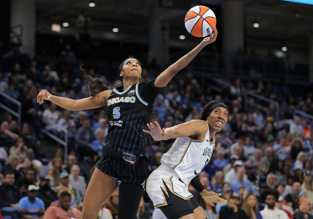 chicago sky's angel reese grabs a rebound over ny liberty's Kayla Thornton in a preseason game